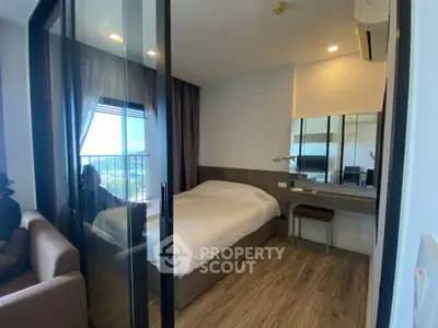 Modern bedroom with glass partition and scenic view, featuring cozy bed and stylish decor.