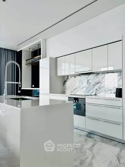 Luxurious modern kitchen with sleek white cabinetry and marble backsplash