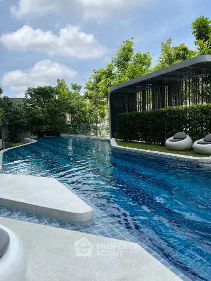 Luxurious outdoor pool with modern design and lush greenery