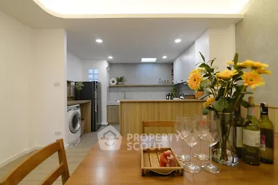 Modern kitchen with open layout, stylish cabinetry, and elegant dining setup.