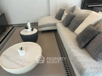 Elegant living room with modern sofa and stylish coffee tables, perfect for relaxation and entertaining.