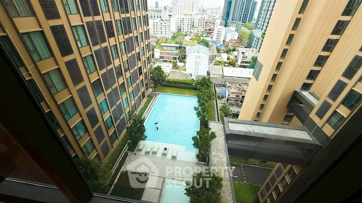 Stunning high-rise view of luxury apartment pool and cityscape