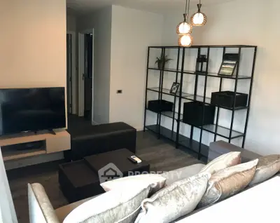 Modern living room with stylish shelving and cozy seating area, perfect for relaxation and entertainment.