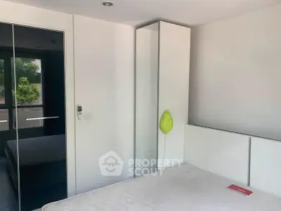 Modern bedroom with sleek design and mirrored wardrobe doors, offering a bright and airy ambiance.