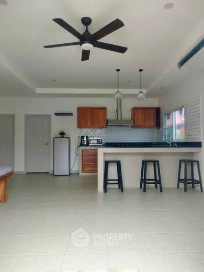 Spacious modern kitchen with open layout and stylish ceiling fan
