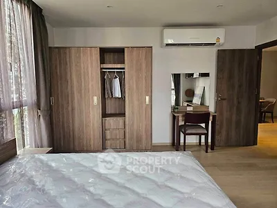 Spacious bedroom with modern wardrobe and air conditioning in a stylish apartment.
