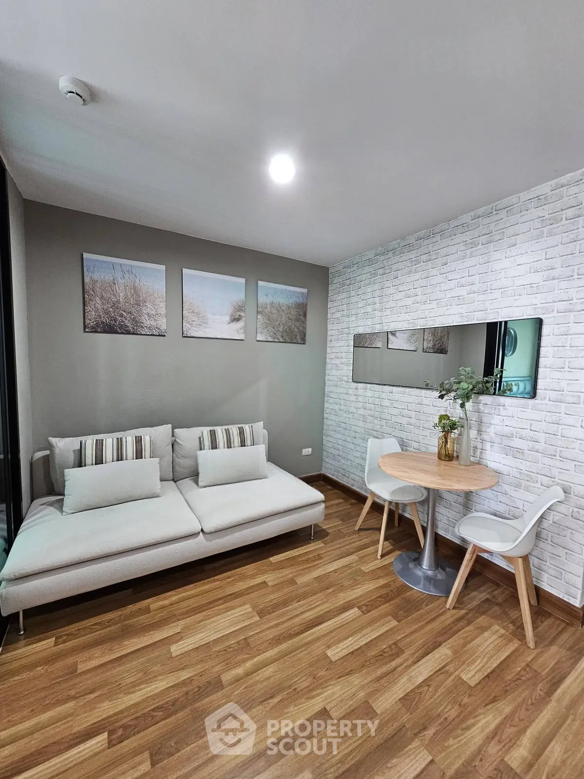 Chic modern living room with cozy sofa and stylish dining area, perfect for urban living.