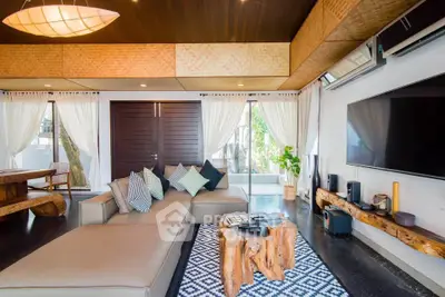 Luxurious living room with modern decor, large TV, and stylish furniture in a contemporary home.