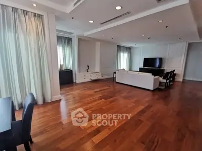 Spacious modern living room with hardwood floors and elegant furnishings.