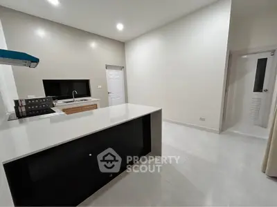 Modern kitchen with sleek countertops and minimalist design in a contemporary apartment.