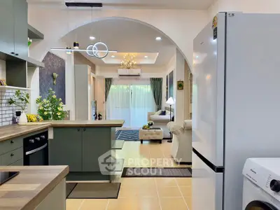 Modern open-plan kitchen and living room with stylish decor and appliances