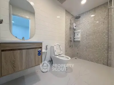 Modern bathroom with sleek fixtures and spacious shower area