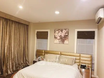 Luxurious bedroom with elegant decor and plush bedding in modern home.