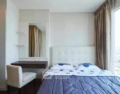 Modern bedroom with elegant decor and large window offering city views