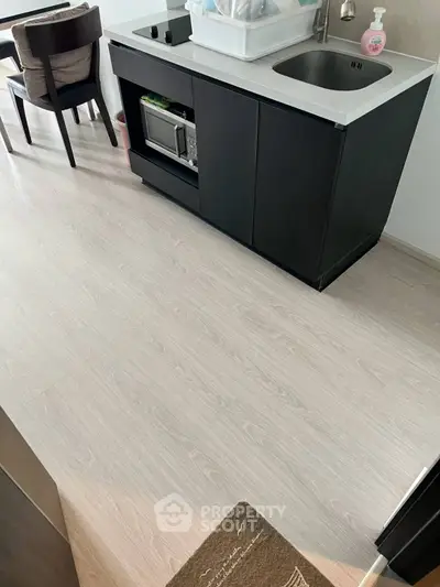 Modern compact kitchen with sleek cabinetry and integrated appliances