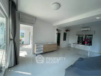 Spacious modern living room with sleek tile flooring and abundant natural light