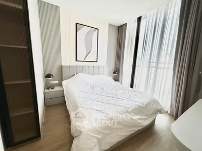 Modern bedroom with stylish decor and large window for natural light