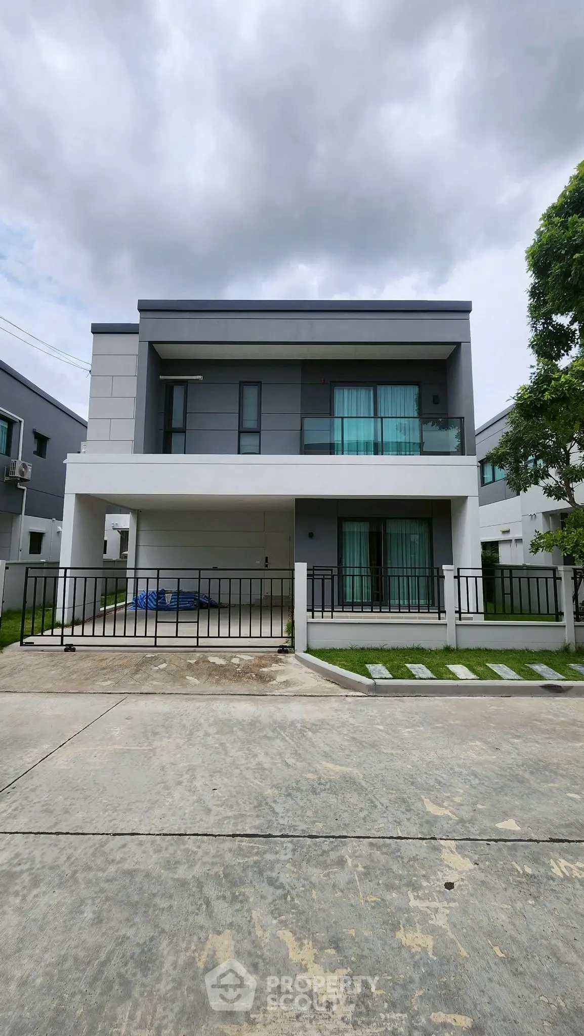 Modern two-story house with sleek design and spacious driveway