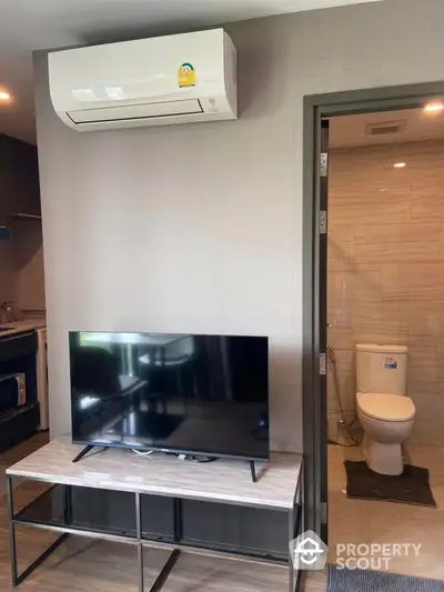 Modern apartment interior with TV and air conditioning near bathroom