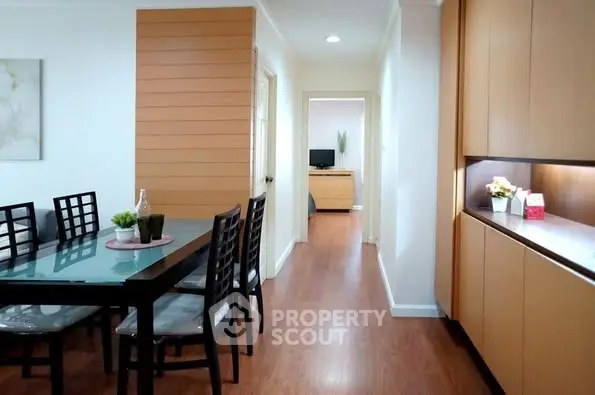 Modern dining area with wooden flooring and sleek furniture