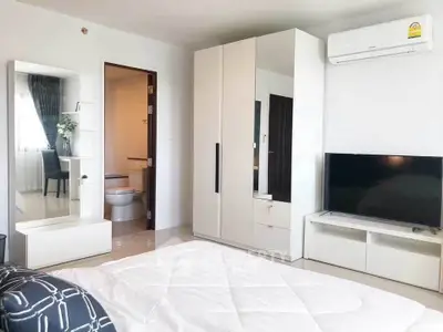 Modern bedroom with sleek furniture and air conditioning