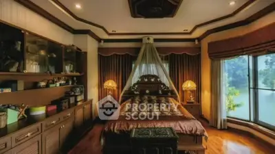 Luxurious bedroom with elegant decor and large windows offering serene views.