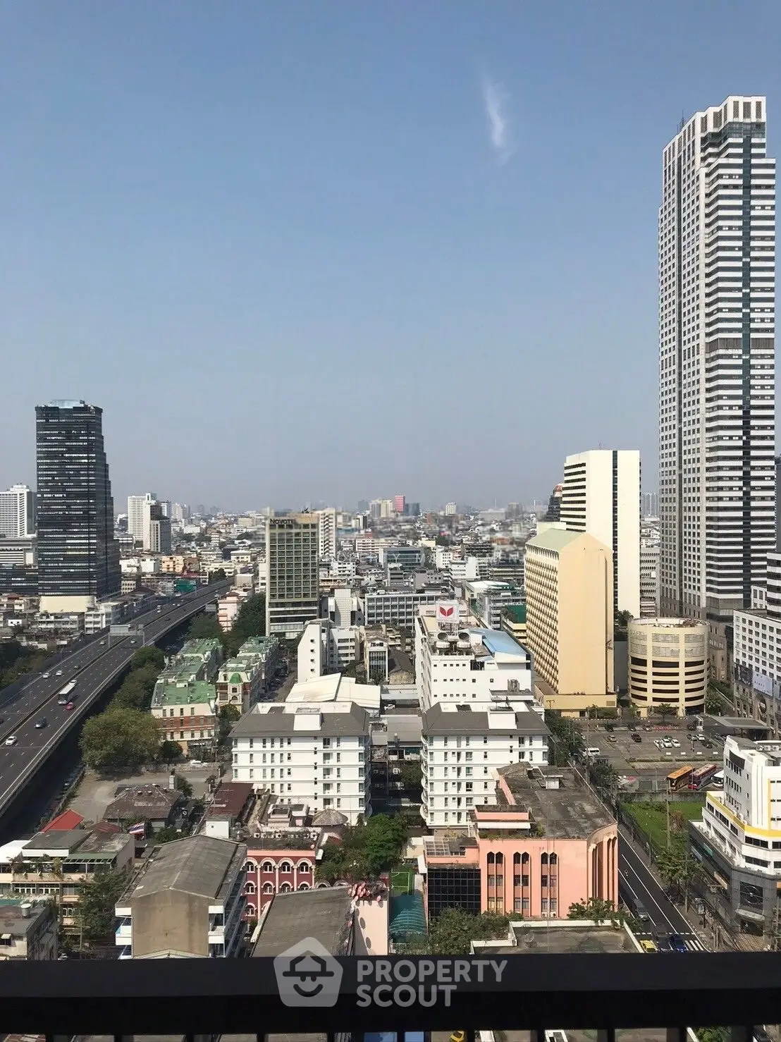 Stunning cityscape view from high-rise balcony showcasing urban skyline and modern architecture.