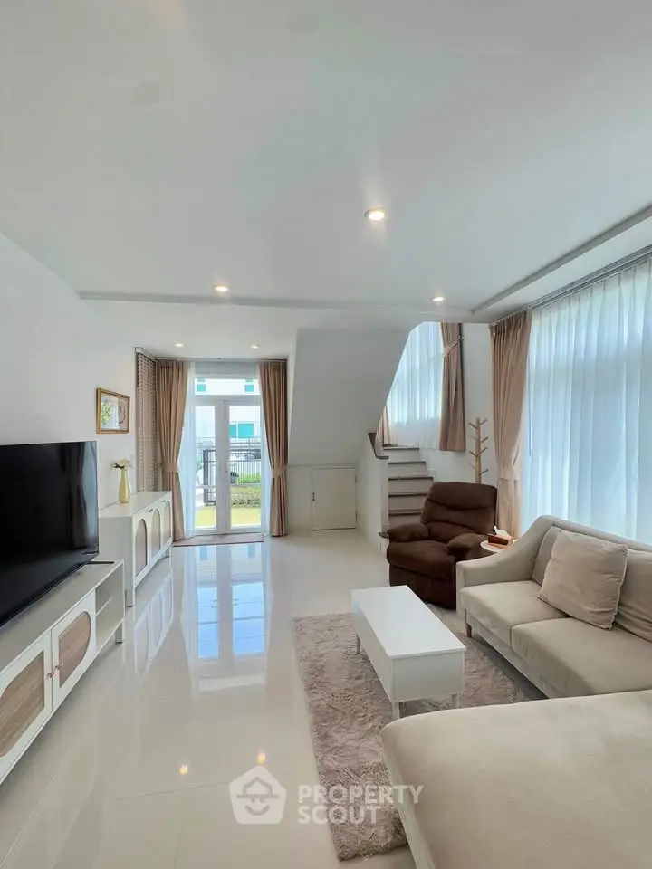 Spacious modern living room with elegant decor and natural light