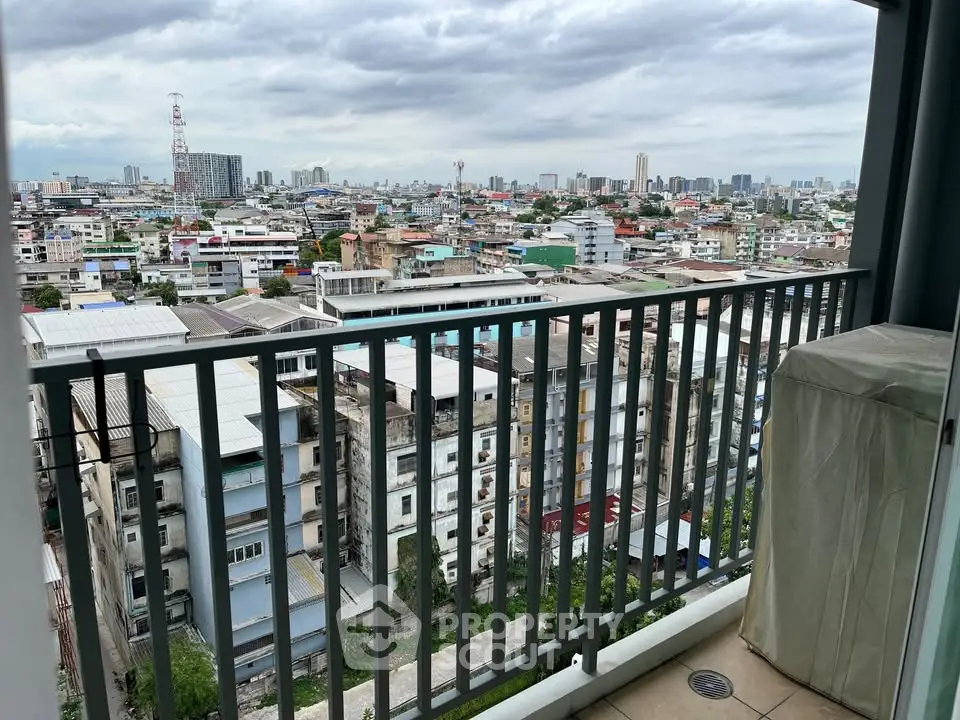 Stunning cityscape view from a high-rise balcony overlooking urban skyline.