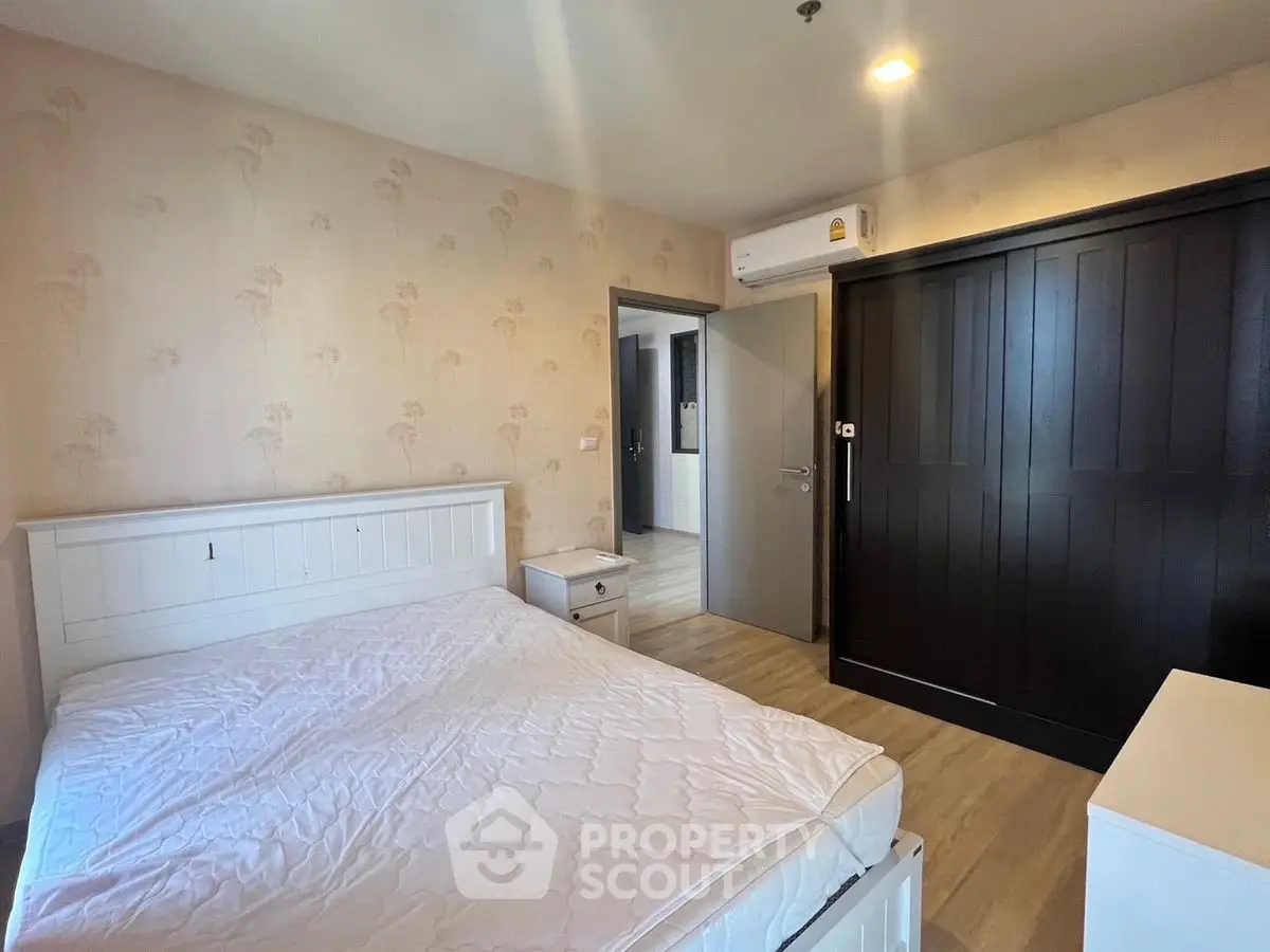 Spacious bedroom with modern furnishings and ample natural light