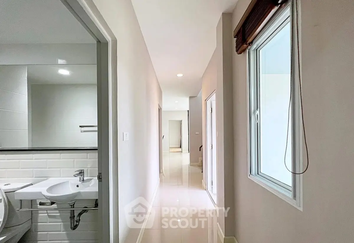 Bright hallway with bathroom view in modern home