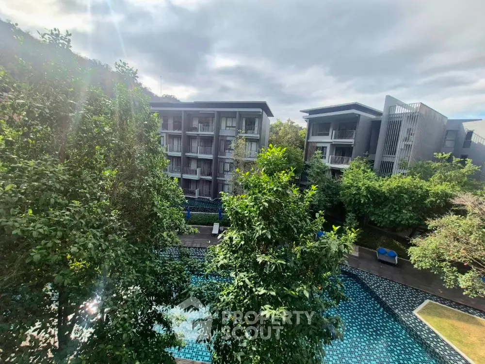Modern residential complex with lush greenery and swimming pool view