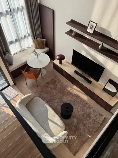 Modern living room with stylish furniture and natural light, featuring a cozy sofa and elegant decor.