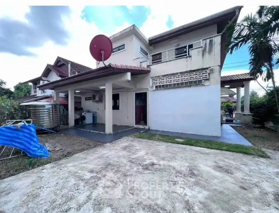 Charming suburban home with spacious driveway and satellite dish, perfect for modern living.