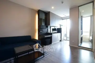 Modern living room with sleek kitchen and natural light, perfect for urban living.