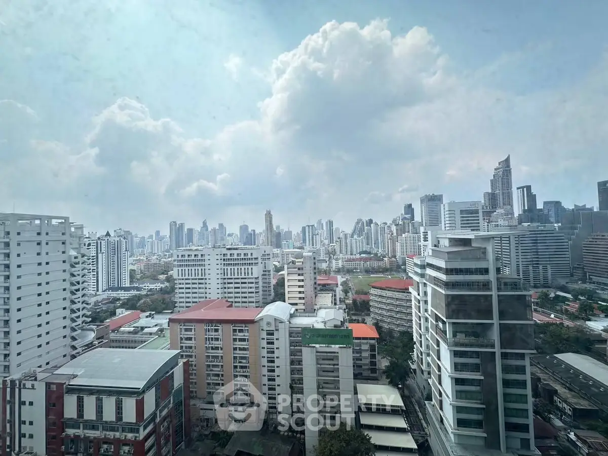 Stunning cityscape view from high-rise building showcasing urban skyline and architectural diversity.