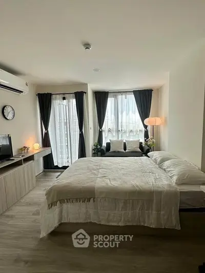 Spacious modern bedroom with elegant decor and natural light