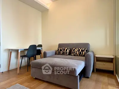 Modern living room with stylish sofa and dining area in a cozy apartment.