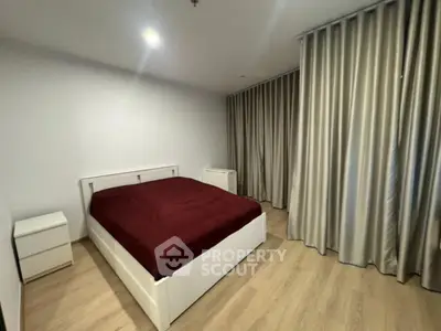 Spacious bedroom with modern design and elegant curtains