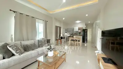 Spacious open-plan living room with modern kitchen and elegant decor