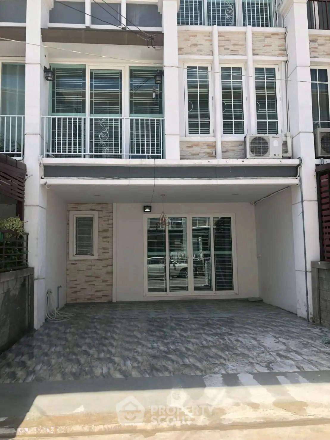 Modern townhouse exterior with spacious driveway and large windows