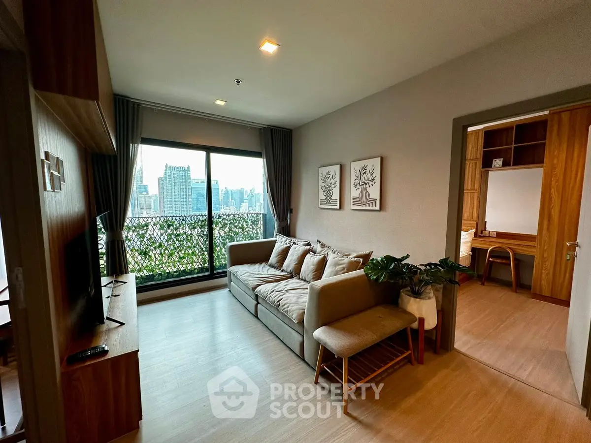 Modern living room with city view, cozy sofa, and stylish decor in a high-rise apartment.
