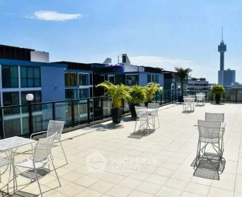 Spacious rooftop terrace with city views and modern seating.