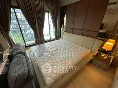 Modern bedroom with large windows and stylish decor in urban apartment