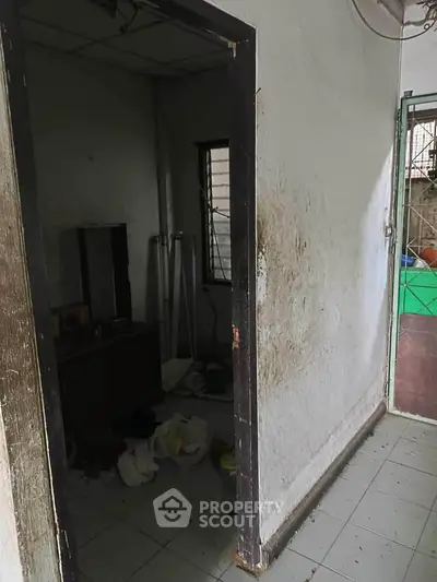 Fixer-upper property with potential, featuring a small room needing renovation.