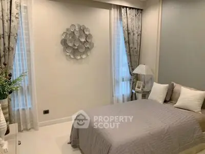 Elegant bedroom with stylish decor and soft lighting, perfect for relaxation and comfort.