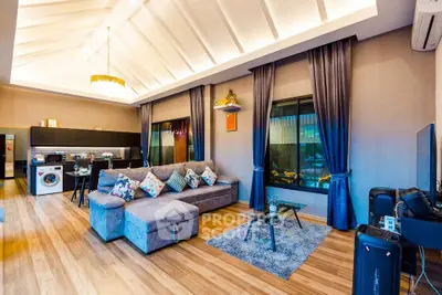 Luxurious open-plan living room with modern kitchen and elegant decor