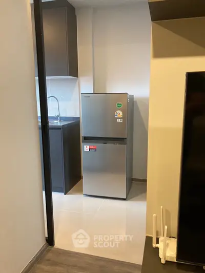 Modern kitchen with sleek fridge and minimalist design