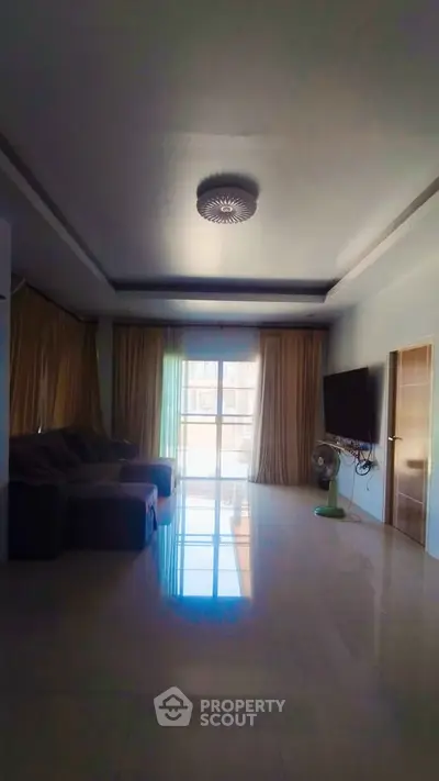 Spacious living room with modern decor and large windows