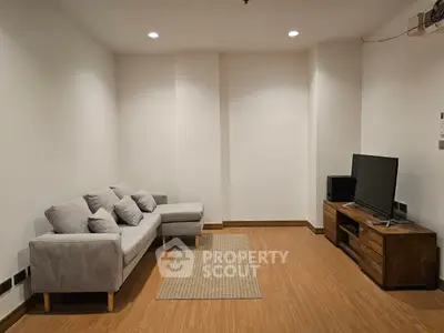 Cozy living room with modern sofa and entertainment unit, perfect for relaxation.